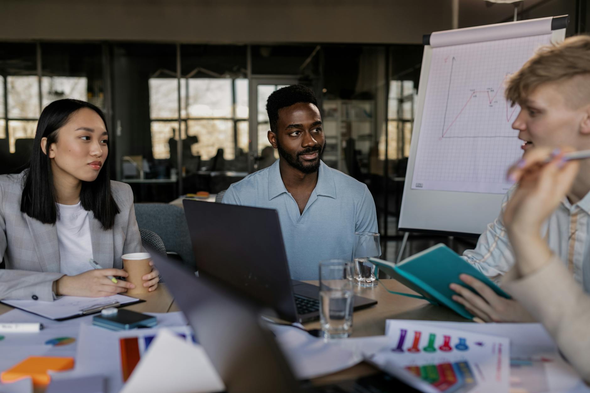 a group of people having a meeting in the office